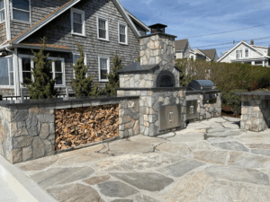 Outdoor kitchen with wood-fired oven and grill built with durable masonry solutions.
