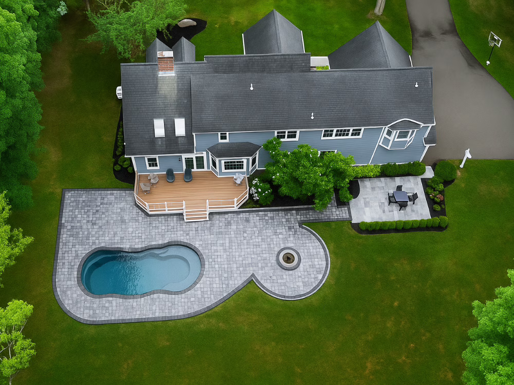 Top-down overview showing full property layout with completed custom pool paver patio project