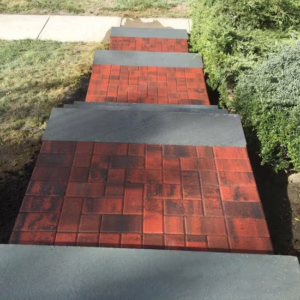 Stair paving installation with brick tiles and concrete steps.