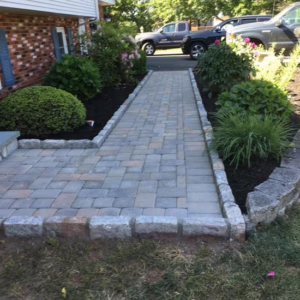 Well-maintained walkway and stone stair features.
