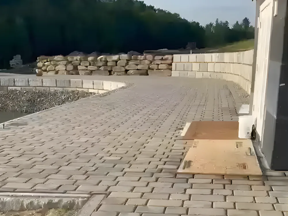 Retaining wall and paved surface by modern utility building
