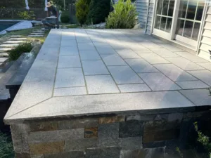 Granite patio installation with precision-cut stone pavers and custom edge detailing